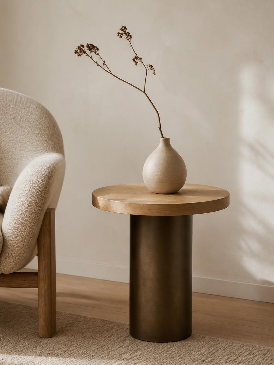 NIOLLO minimalist side table in oak and dark bronze beside a lounge chair